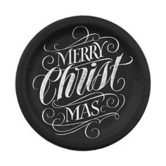 a black paper plate with the words merry christ mas written on it in white ink