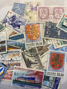 many different postage stamps are stacked on top of each other, including one with the letter s