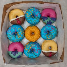 a box filled with lots of donuts covered in frosting