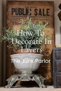 Dive into the world of creative home decorating with 'The Junk Parlor'. Our guide 'How To Decorate In Layers' is your ultimate resource. Unravel the secrets of layering and discover how this technique can breathe life into your living space. It's a step-by-step guide that will transform your home into a stylish haven. Book Displays Ideas, Antique Book Ends Vintage, Small Ledge Decorating Ideas, Tall Wicker Vase Decor Ideas, Styling A Bakers Rack, How To Layer Decor, Arranging Things Colin King, Antique Door Decor, Light Academia Decor Ideas