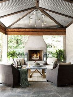 an outdoor living area with furniture and a fireplace