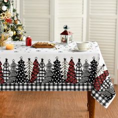 a table with a christmas tree on it in front of a christmas tree and other decorations