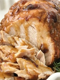 a close up of meat on a plate with gravy and green beans in the foreground