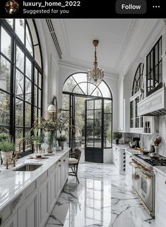 a large kitchen with marble counter tops and white cabinets is featured in this instagram