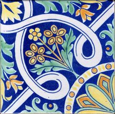 a blue and yellow tile with flowers on it