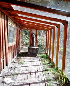 the inside of an old building with wooden beams and brick walkway leading up to it