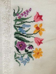 an embroidered piece of cloth with flowers on it