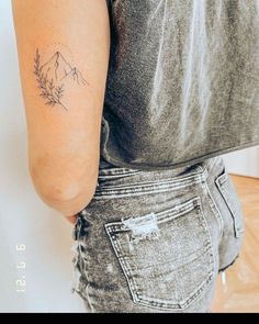 a woman with a small tattoo on her arm