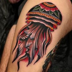 a man with a tattoo on his leg wearing a jellyfish headdress,