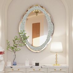 there is a mirror on the wall above a dresser with drawers and a vase next to it