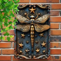 a dragonfly is mounted to the side of a brick wall with stars on it