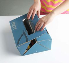 a person is opening up a blue box