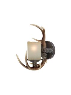 the antler wall light has a white shade on it