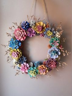 a wreath made out of flowers hangs on the wall