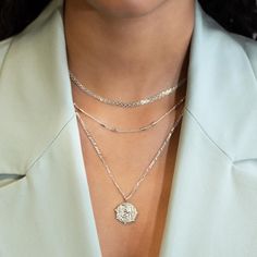 This necklace features a Sterling Silver coin pendant on a Figaro chain. Layer with necklaces from our Patented O collection. Pendant Diameter 0.6in (1.5cm) Figaro chain, 2mm Adjustable chain: 17-19in (44-48cm) When layered, chain length is: 17-21in (44-53cm) Learn more Sterling Silver Spring clasp closure Hypoallergenic, lead and nickel free #290S Elegant Jewelry With Figaro Chain And Medallion, Elegant Medallion Jewelry With Figaro Chain, Layering Jewelry With Cable Chain, Elegant Medallion With Figaro Chain Jewelry, Dainty Chain Necklace For Layering, Silver Pendant Charm Necklace For Layering, Silver Minimalist Layered Necklace With Round Pendant, Coin Pendant Link Necklace As Gift, Coin Pendant Necklace As Gift