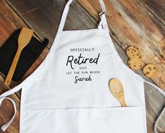 an apron with the words and then there were three on it next to some cookies