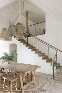 a wooden table sitting under a stair case