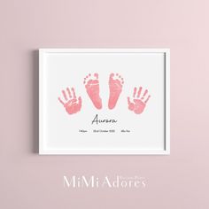 a pink hand and foot print on a white background with the words,'aurora '