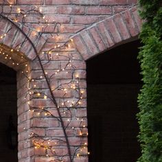 an open brick door with lights on it