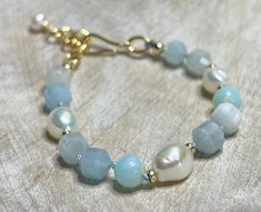 Beautiful faceted blue agate beads, blue opal beads, and freshwater pearls hand knotted on a blue silk cord with gold filled beads and a gold filled hook closure with a 1" extender and a wire wrapped pearl dangle.  Such a simple and elegant beachy bracelet! Approximately 7.5" with a 1" extender. Cheap Blue Pearl Bracelets, Elegant Blue Pearl Bracelet With Natural Stones, Opal Beaded Bracelets, Elegant Blue Adjustable Pearl Bracelet, Beaded Opal Bracelets, Elegant Adjustable Opal Beaded Bracelets, Adjustable Beaded Opal Bracelet, Beachy Bracelets, Bracelet Pearl