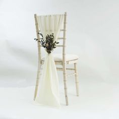 a white chair with a flower arrangement on it