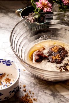 a bowl filled with food sitting on top of a table