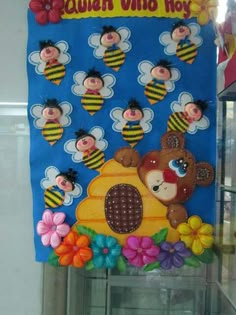 a bulletin board is decorated with bees and flowers