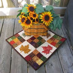 a basket with sunflowers and leaves on a table