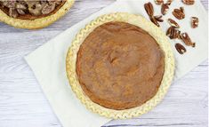 two pecan pies sitting on top of a white napkin next to each other