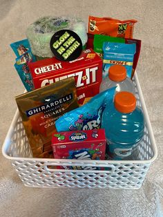 a white basket filled with snacks and drinks