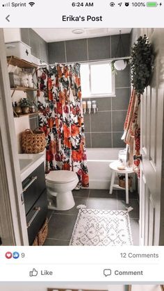 the bathroom is decorated in shades of gray and white with red flowers on the shower curtain