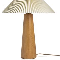 a wooden table lamp with a white shade on the base and a cord attached to it