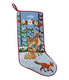 a christmas stocking with an image of two deers and a fox in the snow