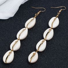 Cowrie Sea Shell Boho Drop Dangle Earrings - Trendy Jewelry Be The Hottest One On The Beach With The Bali Earrings. Do Not Leave For Vacation Without These Must-Haves! Length = 4 Inches Each Pair Comes New In Packaging. Elegant Dangle Earrings For Vacation, Bohemian Style White Single Earring, White Dangle Earrings For Beach, White Dangle Earrings For The Beach, White Drop Earrings For Beach, White Drop Earrings For The Beach, White Teardrop Earrings For Beach, White Earrings With Ear Wire For Vacation, White Ear Wire Earrings For Vacation