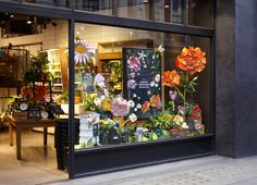 a flower shop with flowers in the window