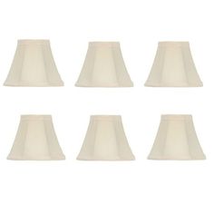 six white lampshades are lined up in the same row on a white background