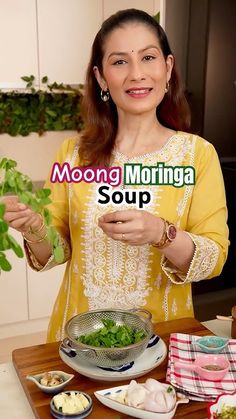 a woman holding up some greens in front of her face with the words moong morning soup on it