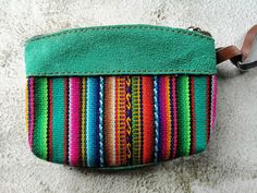 ☀️ 🦙 🌈 If you like vivid colors evoking vibrant Latin style, these one is a perfect choice! Multi colored Peruvian purse made locally with unique traditional hand loomed Cuzco textiles enriched by decoration associated with South American symbolic.   This cute little real leather purse is perfect for holding your cards, coins and other little things. It comes in five different colors. The natural properties of the leather means this purse will age and darken to develop its own unique hint over time.  Chemical dyes have not been used and the natural colors of the hide vary.  The leather is naturally dyed so each bag has its own unique natural color, making them the unique gift you can buy!      * Size 13cm x 10cm  If you have any question don't hesitate to contact me! Bohemian Multicolor Coin Purse For Daily Use, Handmade Green Wallets For Everyday, Handmade Green Wallet For Daily Use, Multicolor Woven Pouch For Everyday Use, Handmade Multicolor Coin Purse, Handmade Multicolor Coin Purse For Everyday Use, Traditional Multicolor Wallet For Everyday Use, Traditional Multicolor Wallet, Handmade Multicolor Coin Purse For Travel