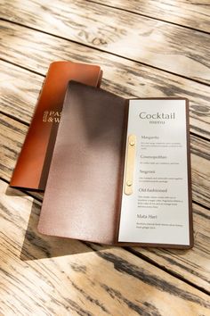 an open menu sitting on top of a wooden table