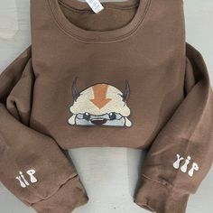 a brown sweatshirt with an image of a bull on it