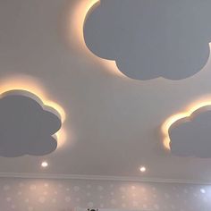 the ceiling is decorated with white clouds and lights