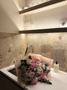 a bouquet of flowers sitting on top of a sink