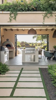 an outdoor kitchen and dining area is shown in this image, with the door open