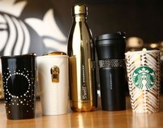 several different types of starbucks cups lined up on a table