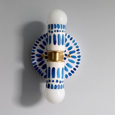 a blue and white wall mounted light fixture