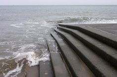 there are steps leading to the water on the beach