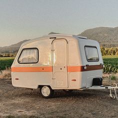 an rv parked in the middle of a field