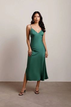 Slip into the Show Up Satin Midi Dress and be the best-dressed guest. This Green satin dress offers adjustable spaghetti straps and a side slit. Complete your wedding guest outfit with drop earrings and strappy heels for a modern, romantic look. Silver Satin Dress, Silver Midi Dress, Holiday Formal Dresses, Slip Dress Outfit, Green Slip Dress, Green Satin Dress, Dress Fancy, Cami Midi Dress, Dress Silver