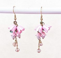 These dainty, pink lily of the valley dangle earrings are handmade by myself.  The flowers are enamel and acrylic, and the wires are gold plated, hypoallergenic, nickel and lead free.  Sparkling crystals catch the light as you move! If you have any questions, please ask.  If something wouldn't be right it would be by accident.  Please let me know so I can help you and make it right.  I want you to be happy! It's best to store the item in a plastic bag to keep it shiny.  I am not sure of the exac Whimsical Pink Dangle Flower Earrings, Whimsical Pink Flower Charm Earrings, Pink Whimsical Flower Charm Earrings, Pink Whimsical Flower Earrings With Flower Charm, Lily Of The Valley Fairy, Pink Lily Of The Valley, Fairy Cottagecore, Cottagecore Jewelry, Lily Of The Valley Flowers