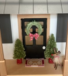 the front door is decorated for christmas with wreaths and pine trees on the mantel